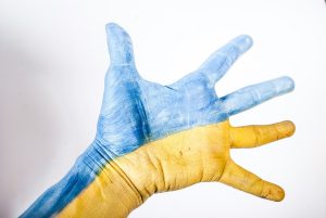 Image of a hand painted in the Ukraine Flag colours - Photo by Elena Mozhvilo on Unsplash